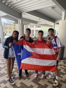 Lyanna De Santis, Ian Bosquez, Edil Bosque, Denniel Gutierrez (left to right) expressing their pride by holding their Puerto Rican flag.