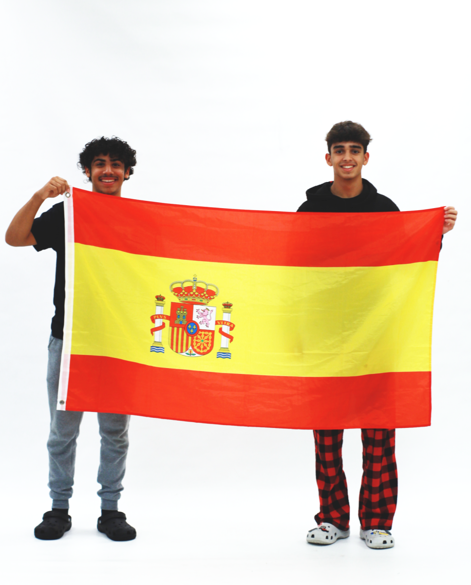 Alex Guncet and Luciano Lamanna Blanco pose with their Spanish flag, honoring their heritage.
