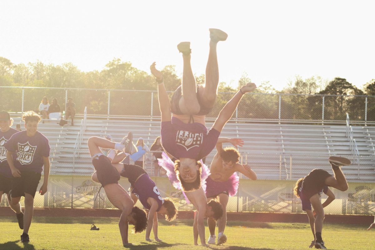 The sophomores flip into action, showing off their acrobatic skills during their cheer performance.