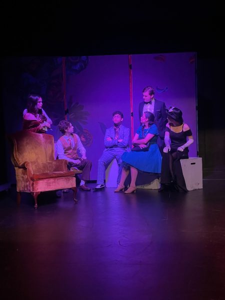The calm before the storm at Boddy Manor.  
Left to Right: Mr. Green (Wyatt Washington), Miss Scarlett (Anilem Munoz), Colonel Mustard (David Caine), Professor Plum (Dylan Lauricello), Mrs. Peacock (Arianna Alvarez), Wadsworth (Bryce Coleman), and Mrs. White (Kaylee Hall) 