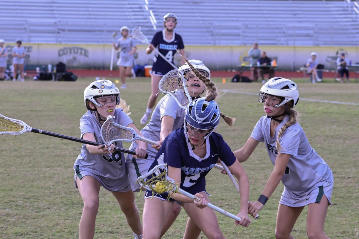 Three against one. Moving to attack an opponent, junior Madison Maziarz, senior Riley Samanka, and sophomore Lexi Zink hold their sticks in preparation. Once the opponent turned around, the ball fell from her stick as it hit Maziarz. 