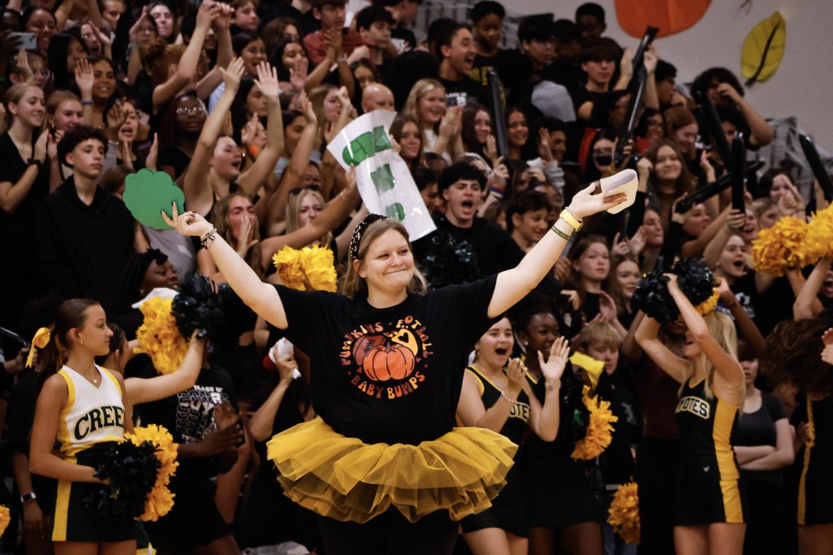 Victorious moment. Kaitlyn Minor, the class sponsor for the freshmen, is seen after the freshman took home a great win. During the 2024 Cypress Creek homecoming pep rally, the freshmen, dressed in black, were victorious at winning tic-tac-toe against the seniors. "It was fun and lit," said freshman, Deuce McAllister, who was cheering from the stands.