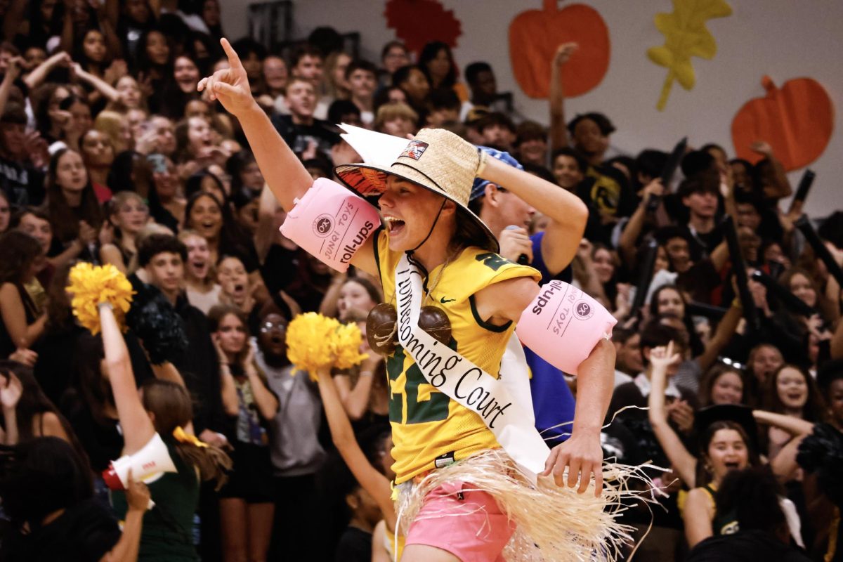 A finger pointed to the sky. Sophomore Roy Ambler just won homecoming court. On the Friday the 13th pep rally, Roy was named homecoming king. He said, "It was like I was on top of the world."