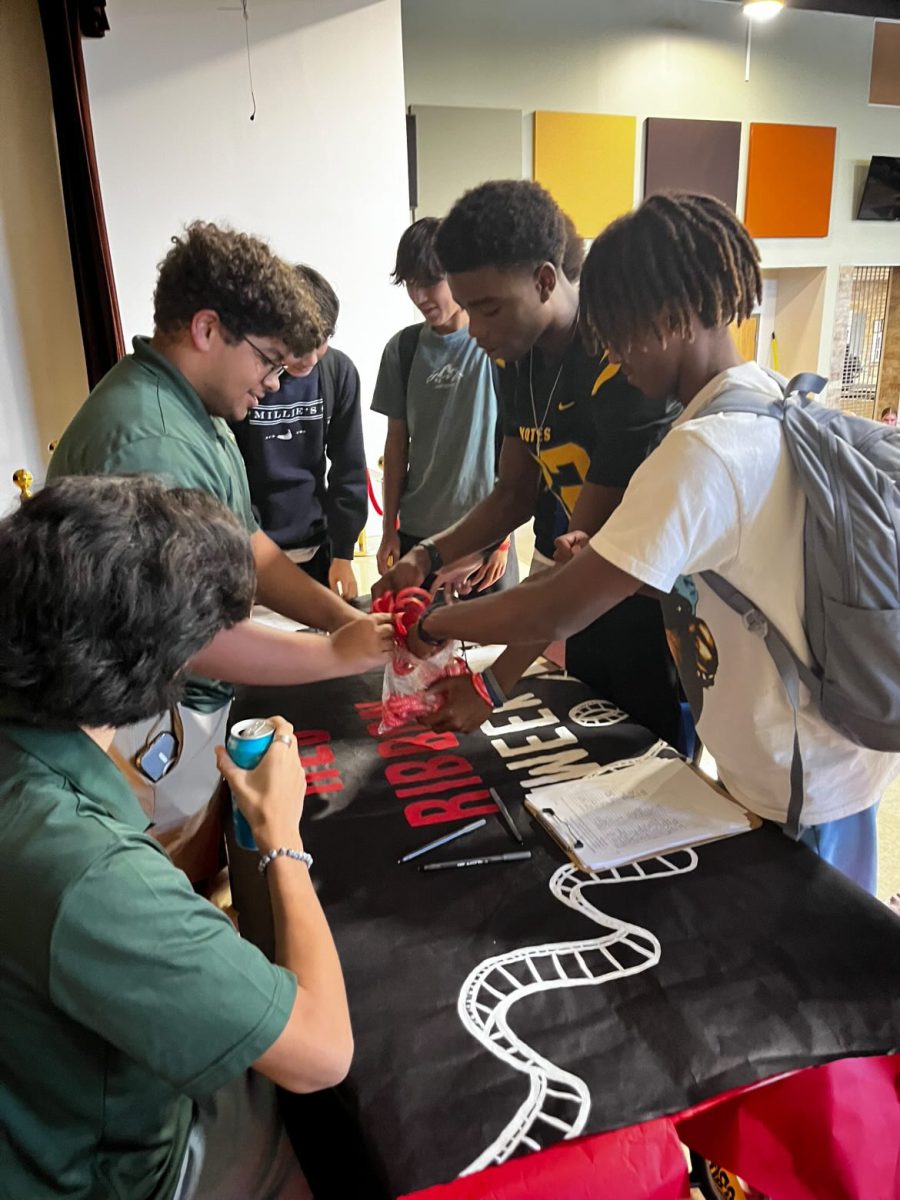 Promise Prizes, Drug free bracelets are handed out to students that sign the pledge as a reward for their pledges. Criminal justice competition team members helped oversee the table and ensured students received their wristbands and Junior Kyran Burkes said “