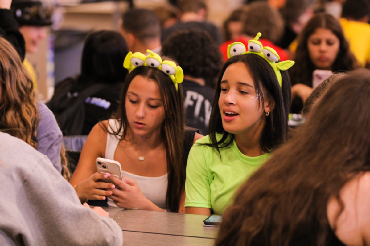 THE CLAWWW!!! Freshmen Chloe Catalanotto and Kylee Axcius dress as the aliens from Toy Story 2 on Halloween Day to Cypress Creek Highschool, enjoying each other’s company. Students dressed as their grade-level theme would be tallied for spirit points, and the highest count out of the grades would win, giving an incentive to dress up. “We love showing school spirit,” said the two girls. 