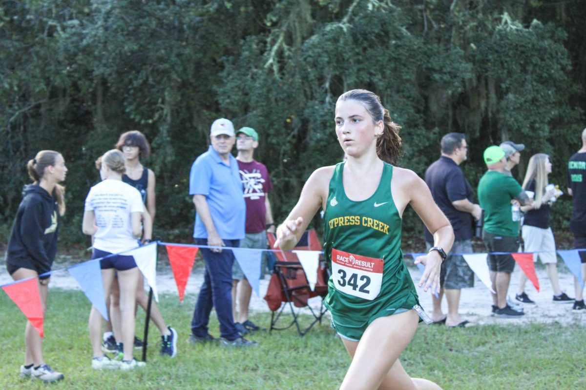   Alexandria Bane running her way through the finish line. 

         “I have a bible verse written on my shoe and it gives me motivation while I am running.” said Bane.