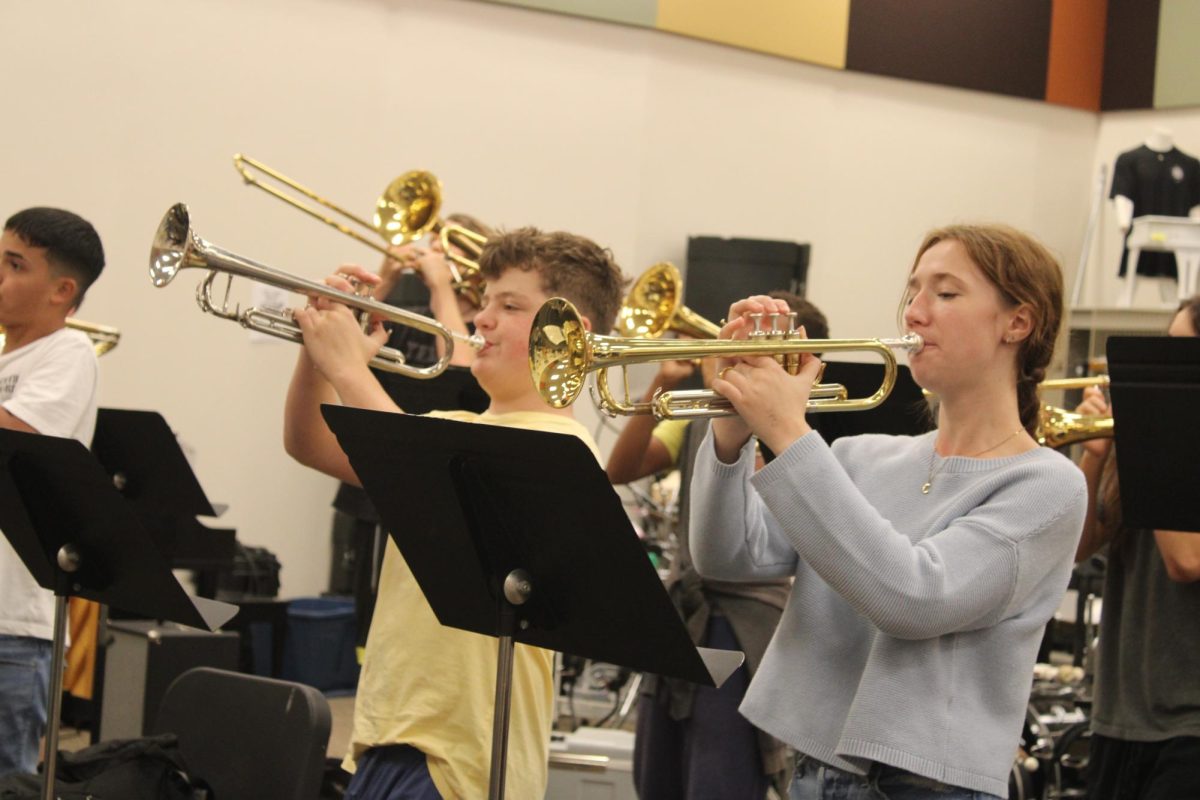 Gold & Silver. Pictured junior Addyson Bergeron and freshman Brayden Adams are playing their gold & silver trumpets with a forte sound.